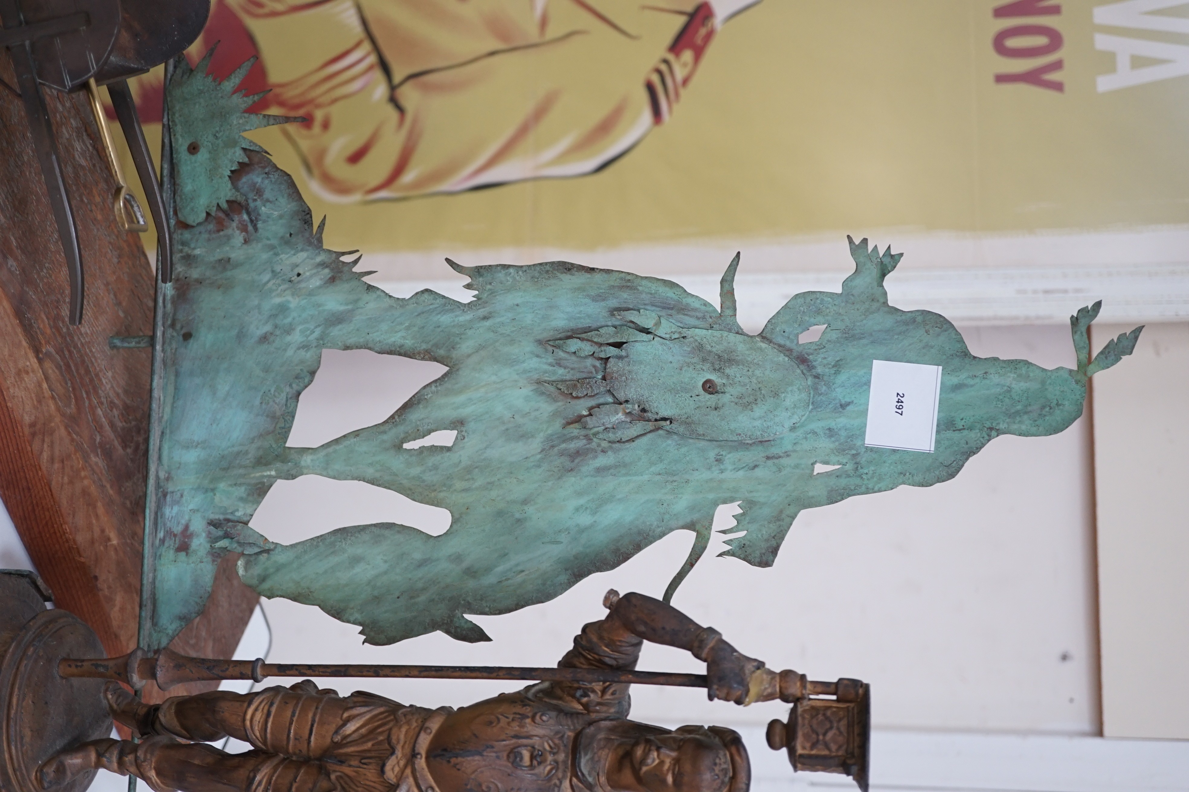 A spelter figural candlestick, a weather vane, a bronze wheel-barrel and a spade, Weather vane 51 cms high not including base